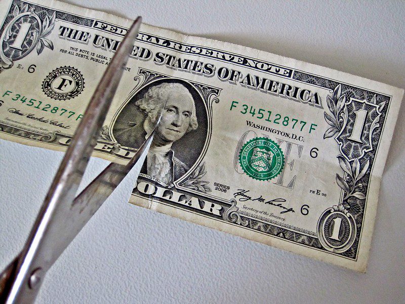 "$1 bill Cut by Scissors" by Images_of_Money is licensed under CC BY 2.0