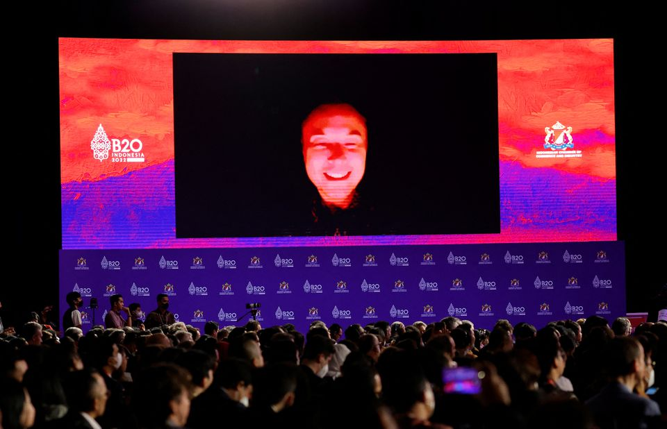 Elon Musk is seen on the screen as he speaks virtually during the B20 Summit in Bali.
