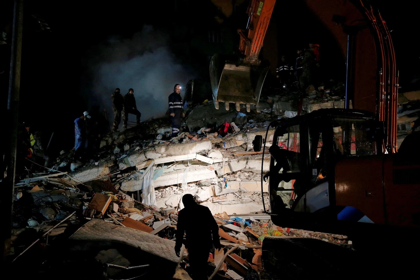 Relief workers working on a collapsed building in Osmaniye, Turkey