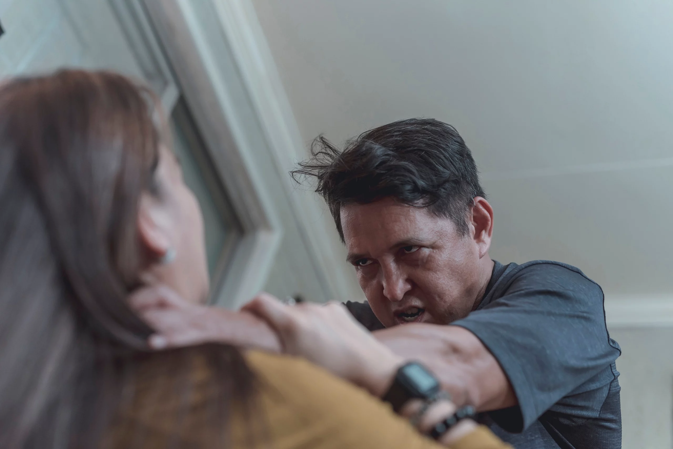 A man goes amok and assaults his wife. Example of domestic abuse and physical violence in couples. Attempted murder and crime of passion scene.