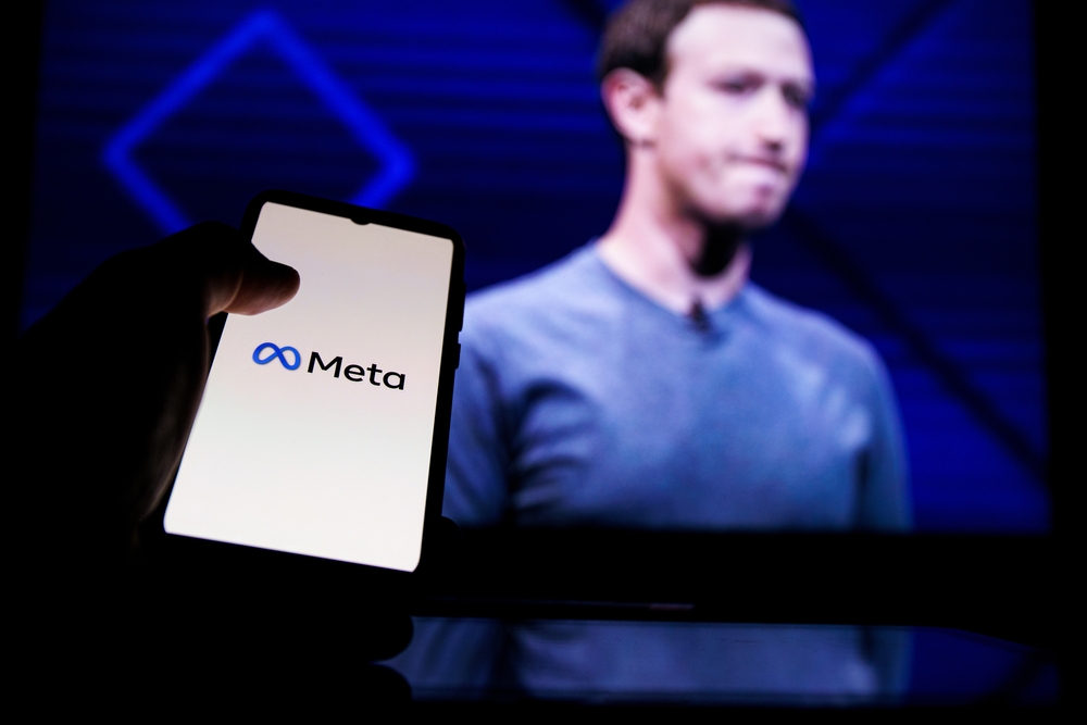 Kaunas, Lithuania 2022 - April 14: Meta logo on screen and Mark Zuckerberg is a Chief Executive Officer of Metaverse in background