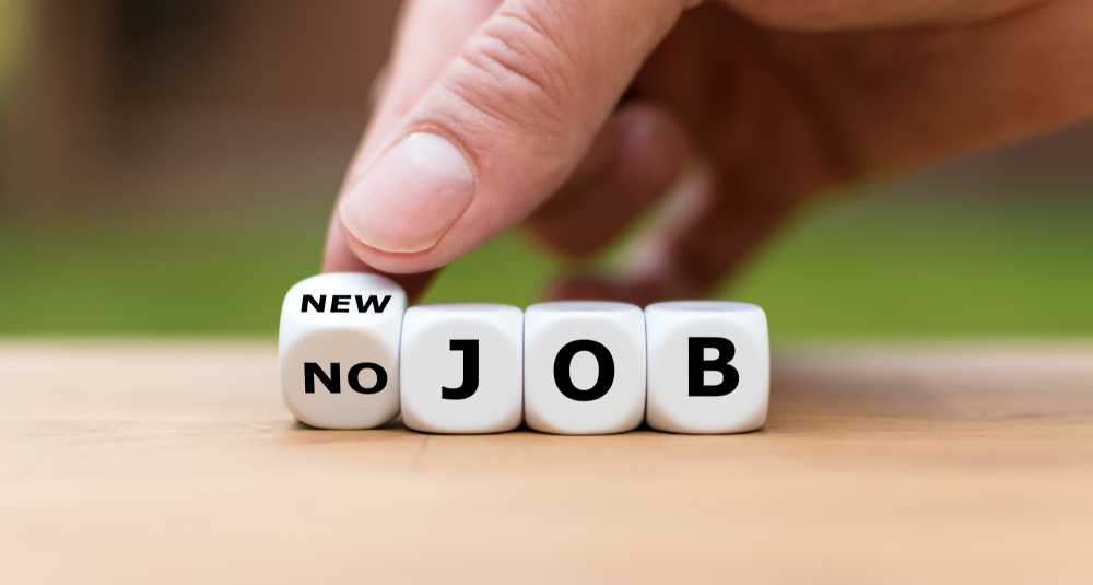 Hand is turning a dice and changes the expression "no job" to "new job"