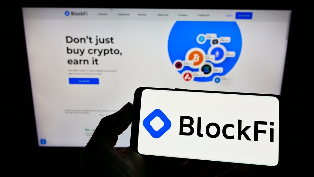 Stuttgart, Germany - 02-20-2022: Person holding smartphone with logo of US cryptocurrency company BlockFi on screen in front of website. Focus on phone display. Unmodified photo.