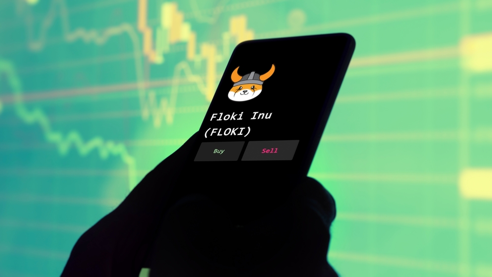 November 3th 2022, Roma. An investor's analyzing the Floki Inu (FLOKI) coin on screen. A phone shows the crypto's prices to invest