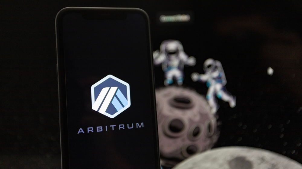 Munich, Germany; 10 March 2023: A man holds an iPhone XR where the logo of the Ethereum layer 2 platform Arbitrum can be seen