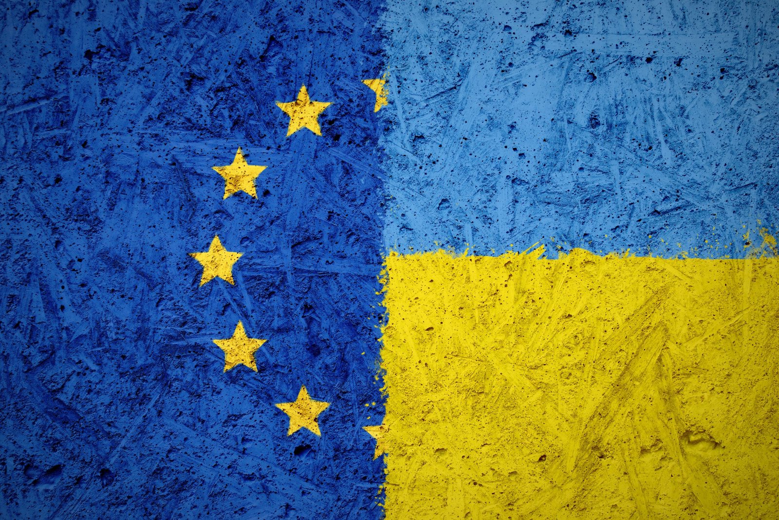 Combination of European Union and Ukraine flags on the concrete texture