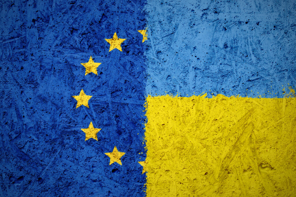 Combination of European Union and Ukraine flags on the concrete texture