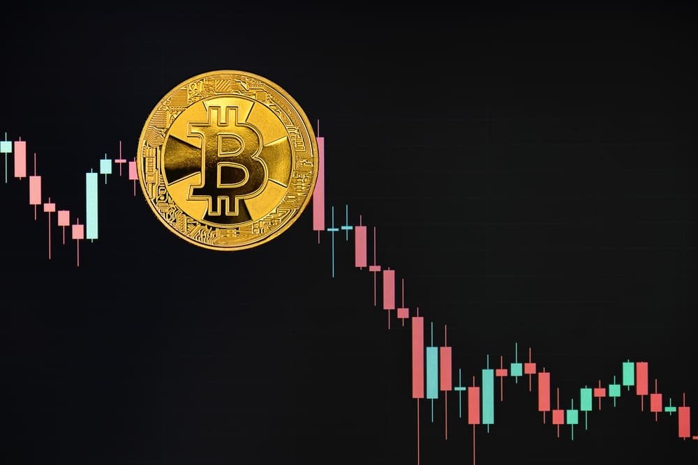 Bitcoin gold coin against the background of the price chart, which shows the price breakdown. Virtual cryptocurrency. Financial growth concept.
