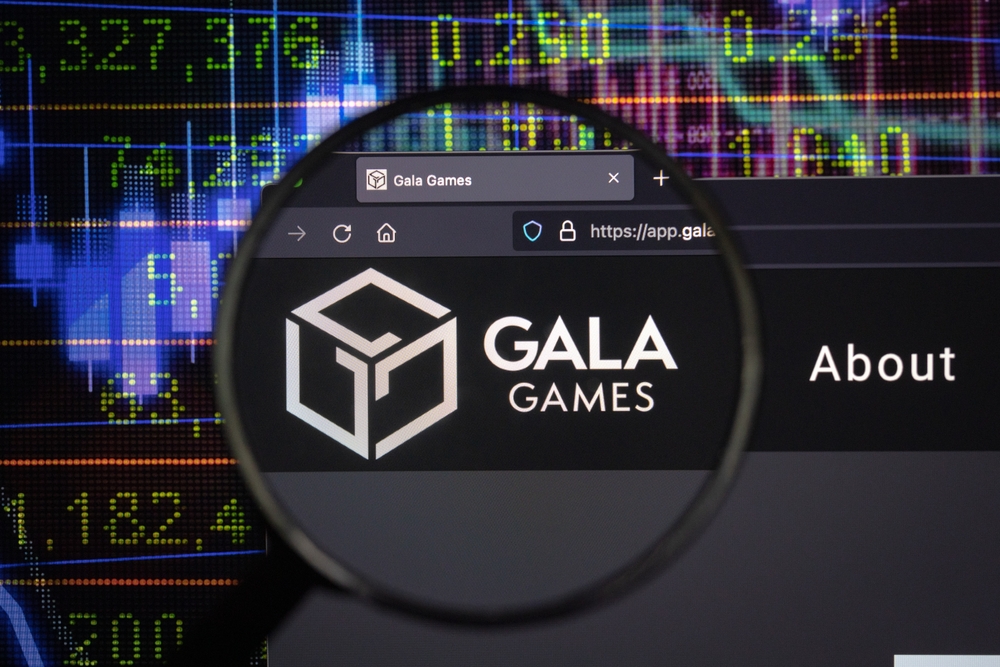 KAUFBEUREN, GERMANY - JANUARY 22, 2022. Gala crypto company logo on a website, seen on a computer screen through a magnifying glass.