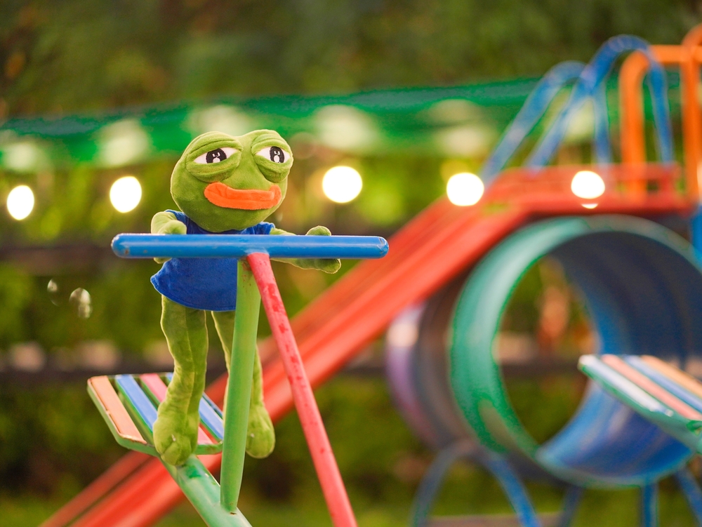 Chantaburi, Thailand - Jan 30, 2022 : A photo of PEPE plush doll. Pepe the frog is a famous character from Boy's club comic. He is playing see-saw in the playground.