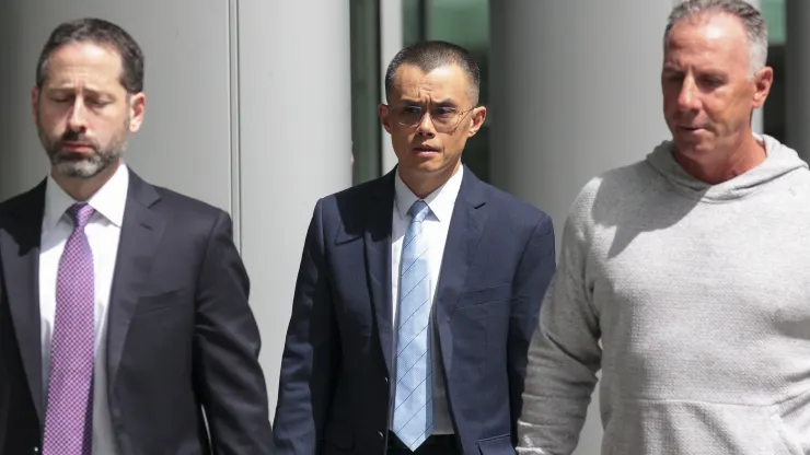 Former Binance CEO Changpeng Zhao, center, departs federal court in Seattle on April 30, 2024.